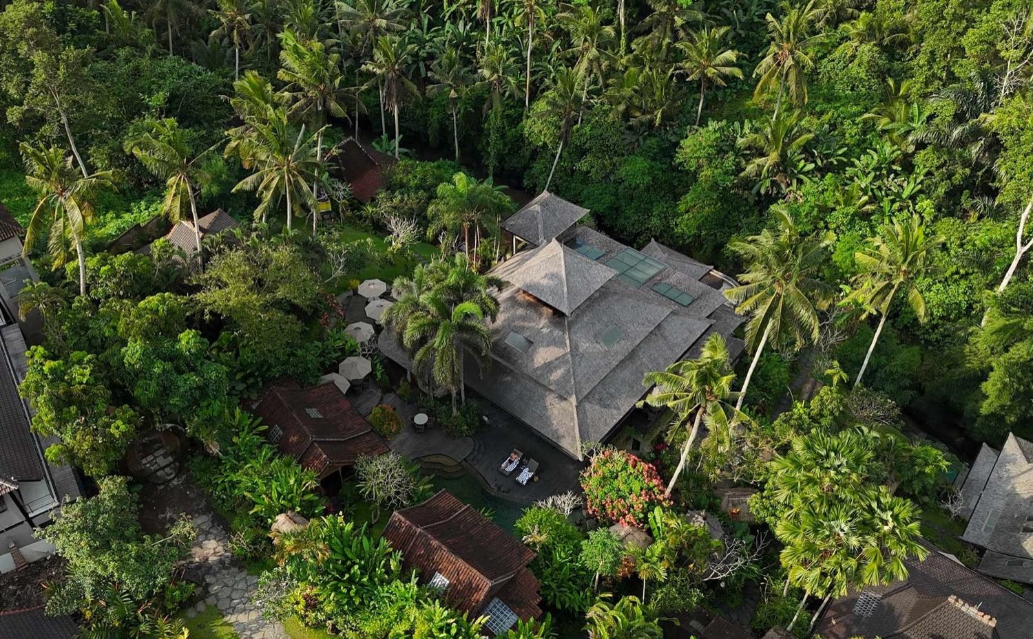 The sanctuary from above, the vaulted roof of the yoga shala and the cottages under the palm canopy of the Wos River valley